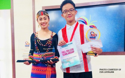 <p><strong>ASEAN BEE CHAMP.</strong> Grade 10 Baguio National High School student Jericho Villarico (right) and his coach, Eva Layagan (left), display their prizes after finishing champion at the 8th National ASEAN Quiz Bee organized by the Presidential Communications Operations Office, Department of Foreign Affairs, and Department of Education in Quezon City on April 3-6, 2018. Villarico is now about to prepare for the international level quiz tilt to represent the Philippines in Bali, Indonesia later this year. <em>(Photo by Eva </em>Layagan<em>)</em></p>